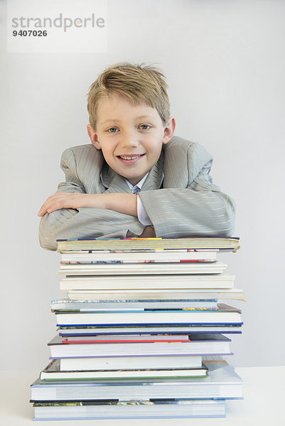 angelehnt Portrait Buch lächeln Junge - Person Stapel