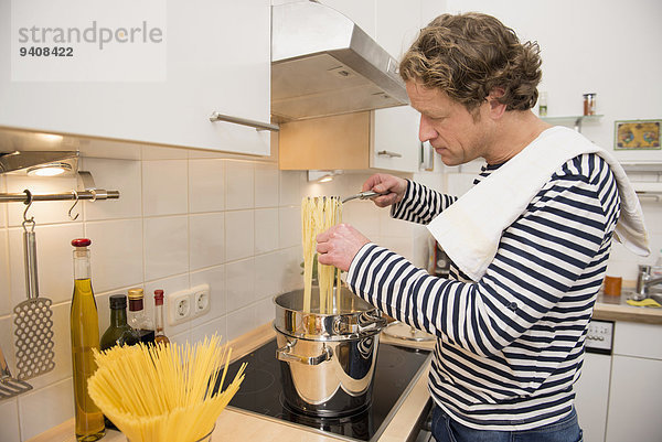 kochen Mann Küche Spaghetti