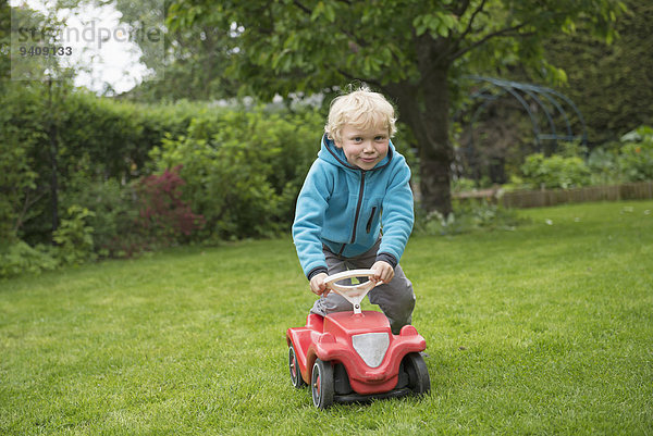 Junge - Person Auto klein Spielzeug Garten blond spielen