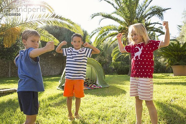 Drei Kinder in der Gartenmuskulatur