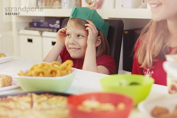 Kinder mit Papierkronen zu Weihnachten