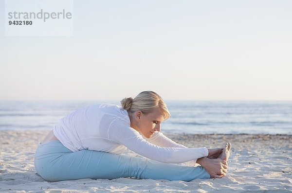 Frau beim Yoga-Gebet am Strand