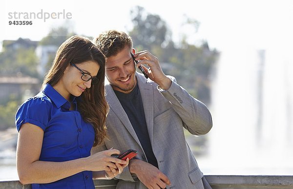 Geschäftsmann und Frau mit Smartphone