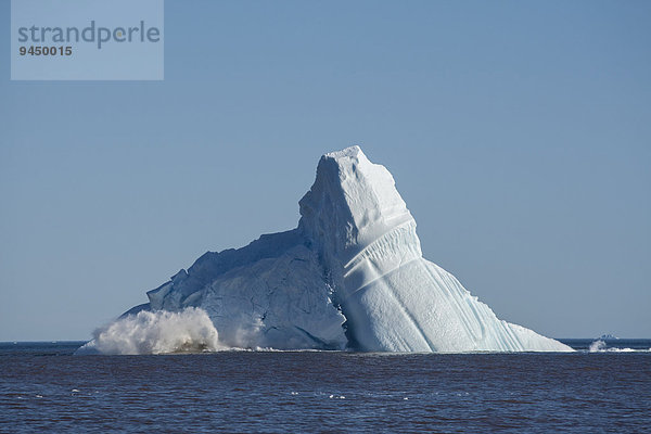 Eismassen brechen von einem enormen Eisberg ab  so dass er aus dem Gleichgewicht gerät und kollabiert  Qeqertarsuaq  Diskobucht  Grönland