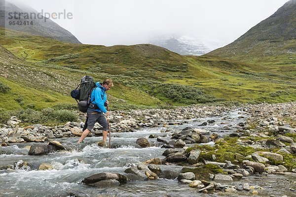 überqueren Berg Mann Fluss