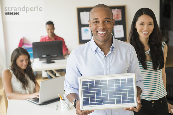 Geschäftsmann Modell halten Büro Sonnenkollektor Sonnenenergie Tisch