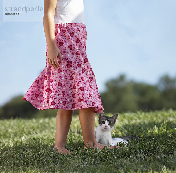 Junges Mädchen auf Rasen stehend mit Kätzchen  niedrige Sektion
