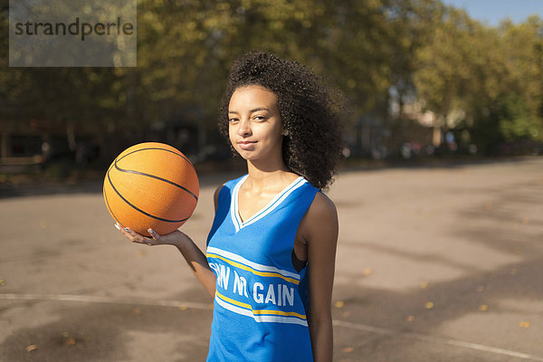 Portrait junge Basketballspielerin beim Basketball