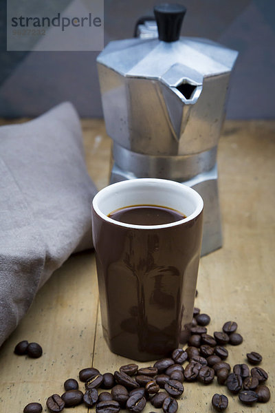 Tasse Kaffee  Tuch  Espressodose und Kaffeebohnen