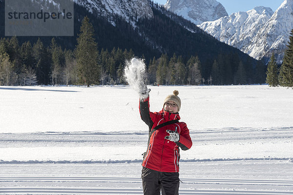 Austria  Tyrol  Pertisau  young woman throwing snowball