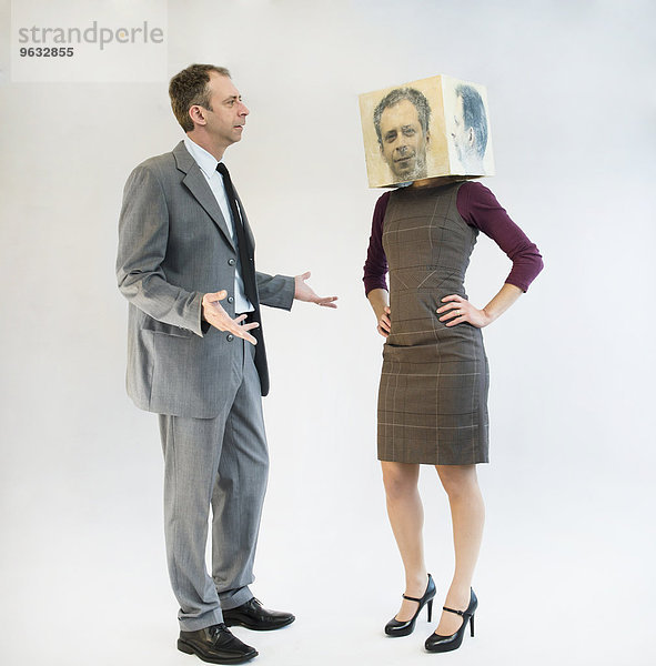 Businessman arguing with businesswoman wearing mask