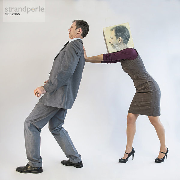 Businessman being pushed by businesswoman wearing mask