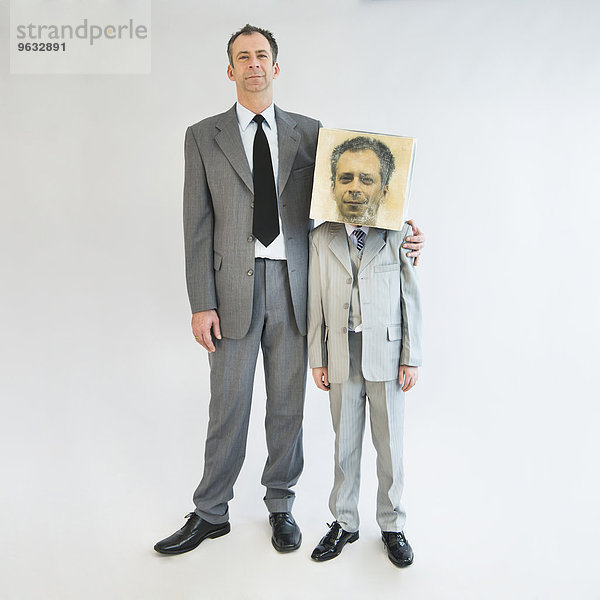 Businessman showing unity and standing near boy wearing mask