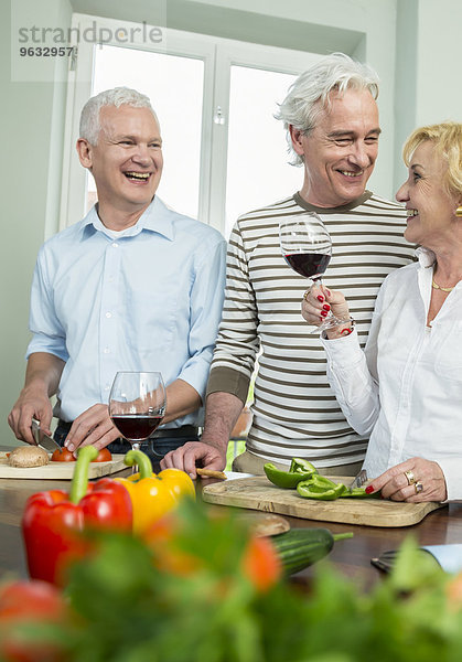 Senior men woman kitchen preparing dinner talking