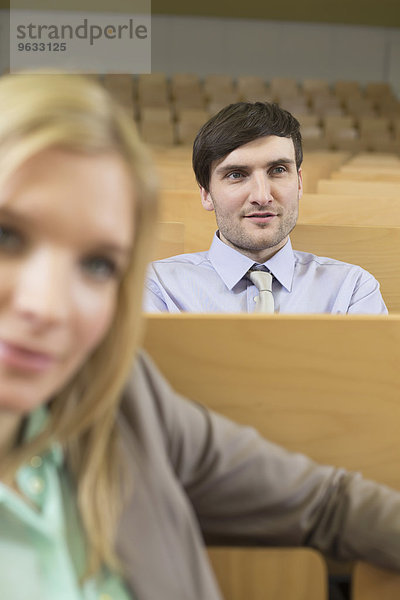 Businesspeople sitting in auditorium