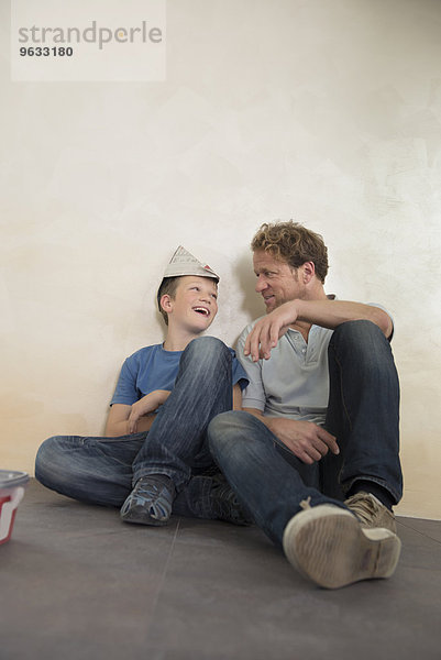 Father son bonding fun happy sitting floor