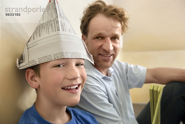 Boy paper hat father smiling bonding fun