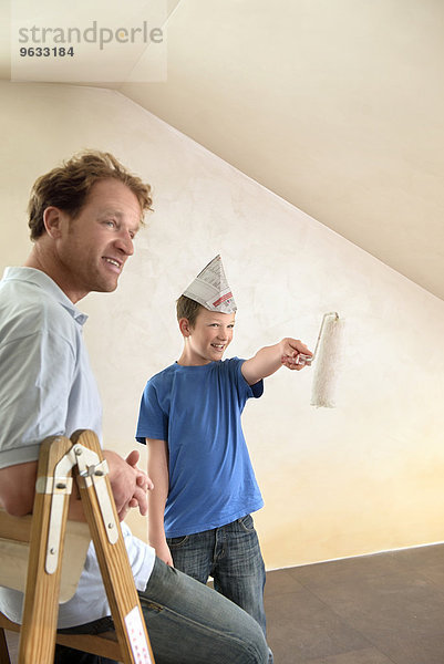 Father young boy painting decorating room happy