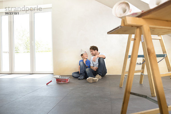 Father son working taking a break painting