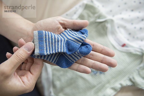 Close-up woman hands holding baby socks