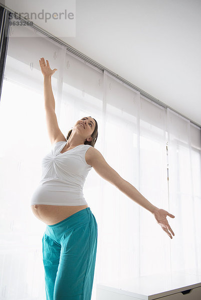 Young pregnant woman happy dancing posing