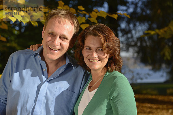 Portrait of couple in autumn  smiling