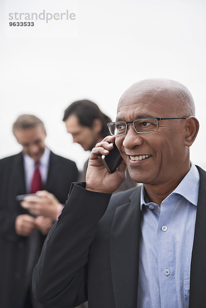 Businessmen busy meeting SMS cell phone Teamwork