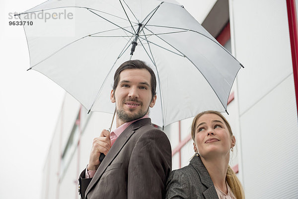 Young couple rain umbrella protecting protection