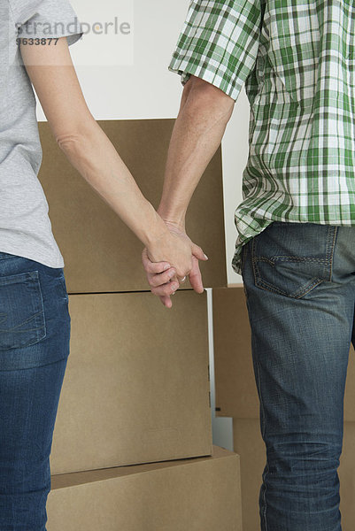 Close-up couple holding hands new home