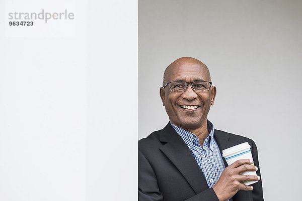Businessman smiling African Coffee to go happy