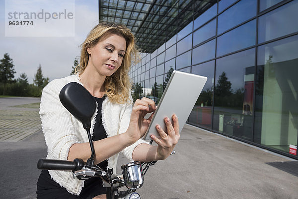 Businesswoman electric scooter tablet computer
