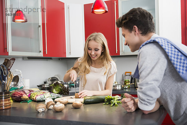 Young couple preparing food in kitchen