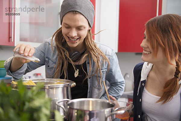 Young couple cooking together in kitchen