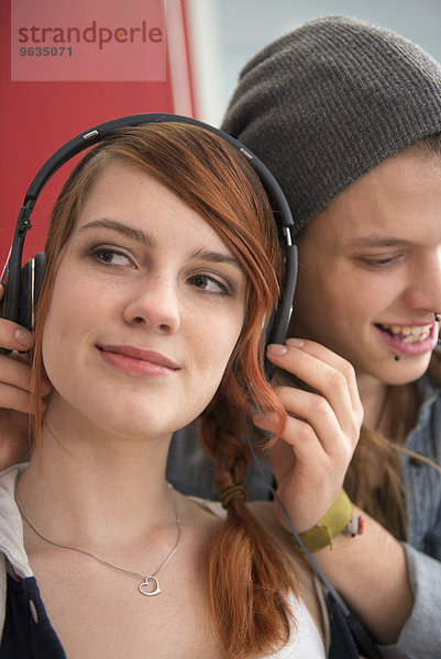 Young couple listening to music