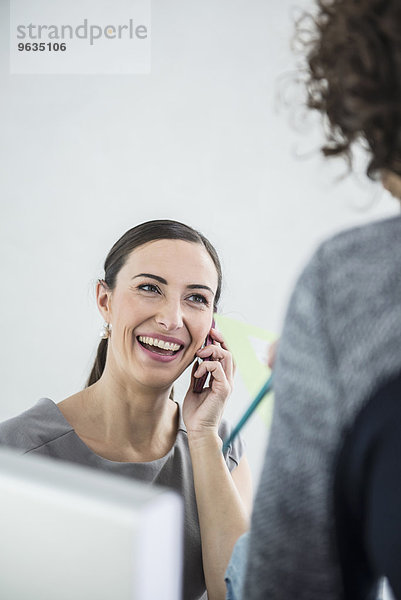 Businesswoman talking on mobile phone in an office