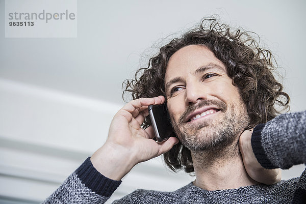 Businessman talking on mobile phone in an office