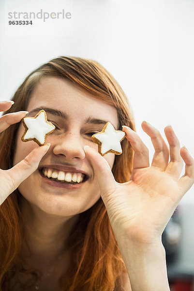 Close up of a red-haired young woman with cinnamon stars as eyes