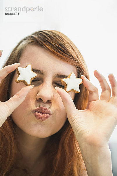 Close up of a red-haired young woman with cinnamon stars as eyes