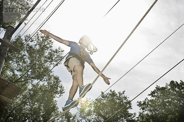 teenager balancing in a climbing crag