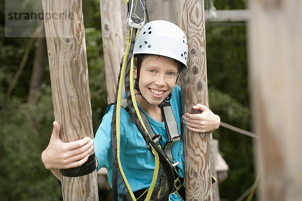 Portrait of boy climbing crag  smiling