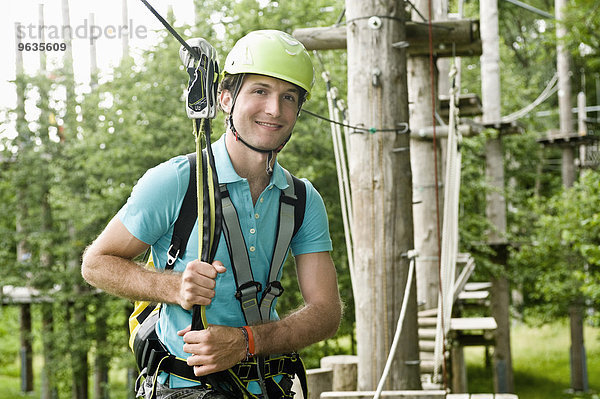 Portrait of young man climbing crag  smiling