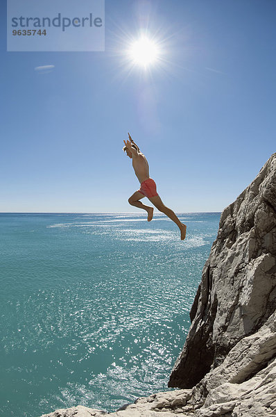 Teenager risk danger ocean holiday jump dive water