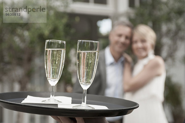 Man woman party waiter delivering champagne