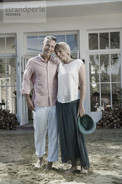 Holiday couple house sand standing portrait