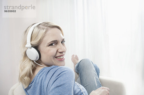 Young woman chair listening music headphones