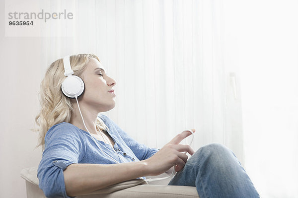 Woman eyes closed listening music headphones