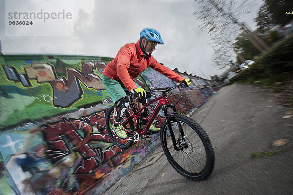 Mountain bikers balanced on front wheel into the city