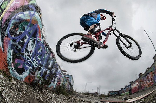 Mountain biker stunts on road