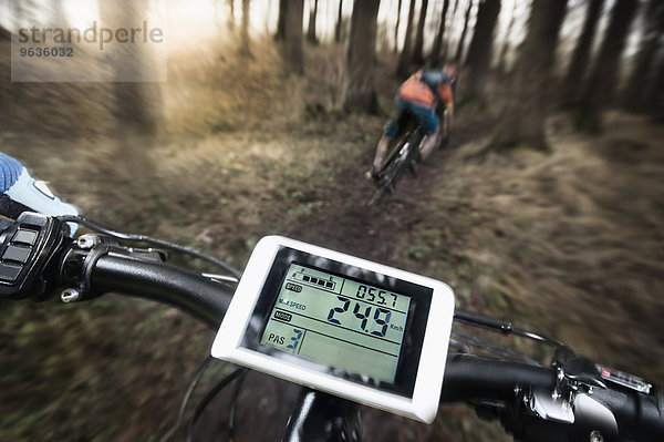 Driving view of mountain biking down hill descending fast on bicycle