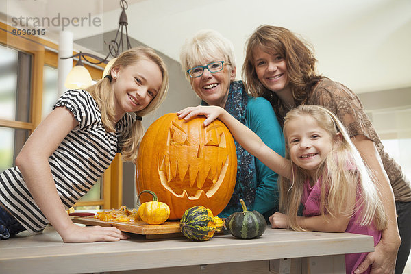 Family preparing pumpkin for Halloween